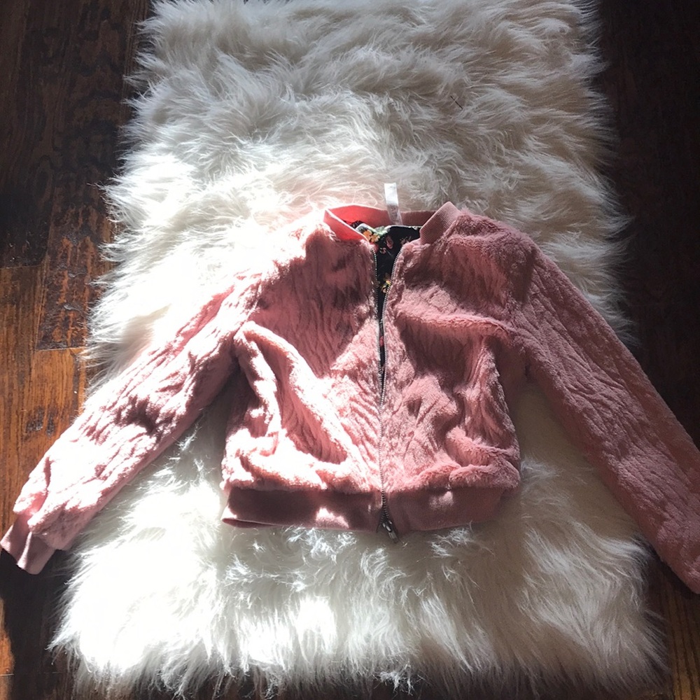 A soft pink jacket with flower detailing inside🌸
